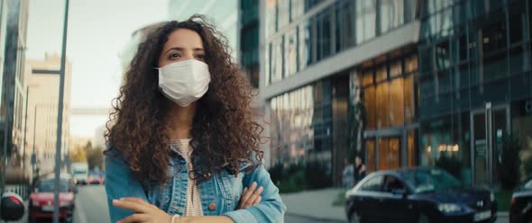 Video of woman in protective mask waiting on the sidewalk. Shot with RED helium camera in 8K.