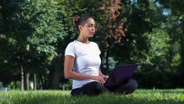 Female Student Working on Laptop in the Park