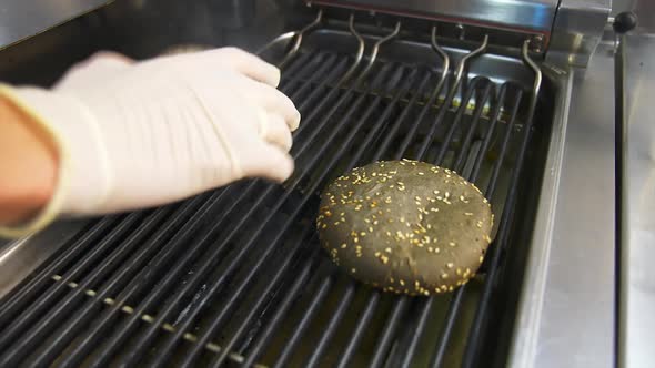 Chef cooking hamburger in restaurant. Close up of the preparation of magnificent burger in restauran