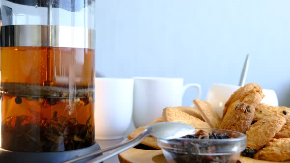 Jar with tea drink man hand filtering tea in glass.