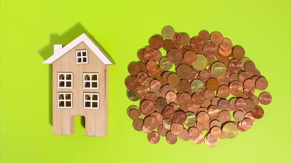 Stop Motion Animation Euro Coins on a Green Background Move Around and Next to a Wooden House