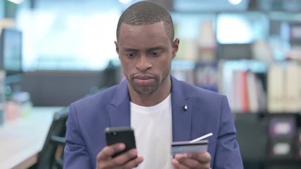Portrait of African Businessman Making Online Payment on Smartphone