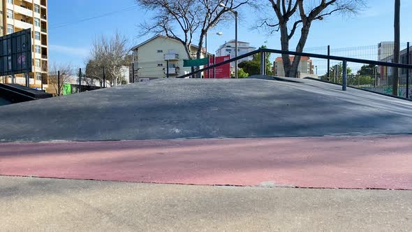 Skater man riding and doing a backside snap on skateboard on sunny day