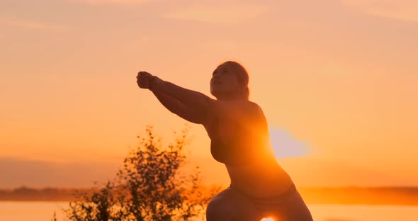 SLOW MOTION, LOW ANGLE, CLOSE UP, SUN FLARE: Athletic Girl Playing Beach Volleyball Jumps in the Air