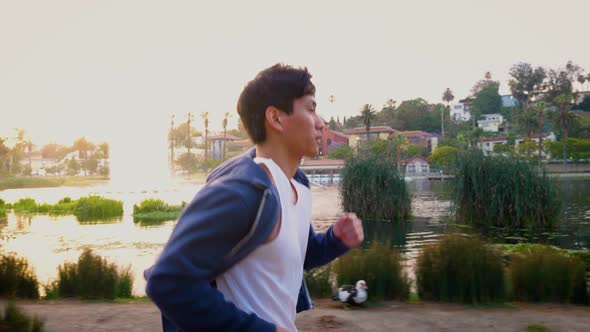 Young Asian man working out in a park in Los Angeles.