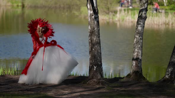 Red Queen in Gorgeous Dress is Walking in Forest Near River Fantastic Character From Fairytale