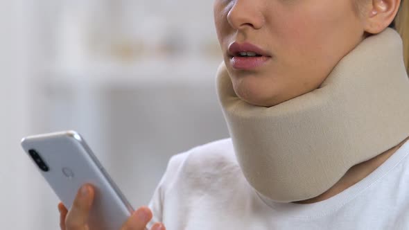 Upset Woman in Foam Cervical Collar Talking Phone, Feeling Neck Pain, Trauma