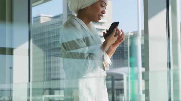 Businesswoman using smartphone in modern office building