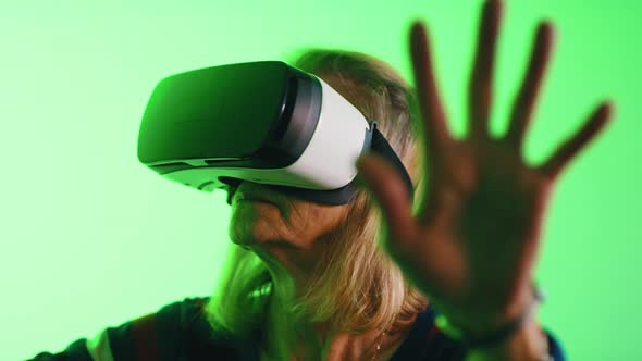 Senior Woman Enjoying VR Indoors