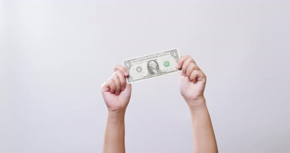 Women Holding American Dollar Currency. The woman's hand shows One dollar in white studio background