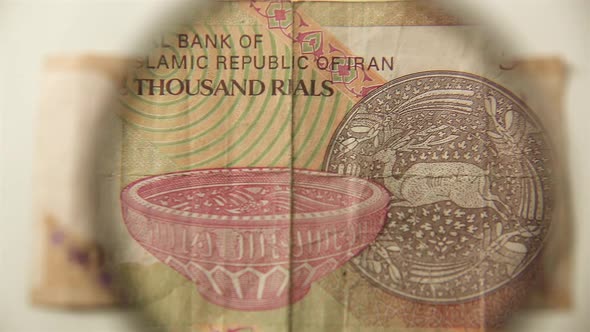 Five thousand Iranian rials and a magnifying glass.
