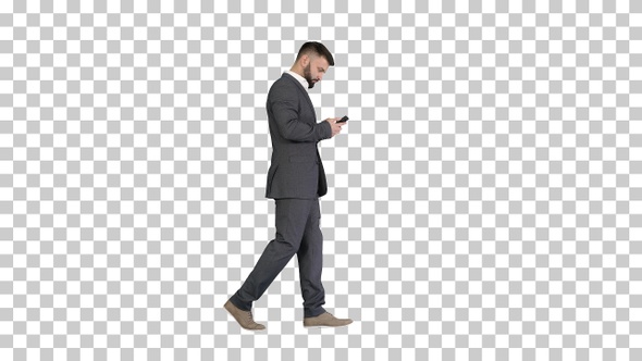 Businessman walking and text messaging, Alpha Channel