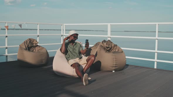 Guy Video Calling on Pier