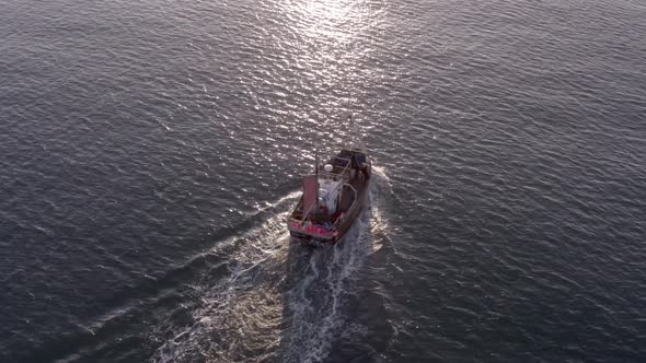 Fishing Boat in the Early Morning Heading Out to Sea