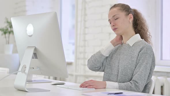 Young Latin Woman Having Neck Pain in Loft Office