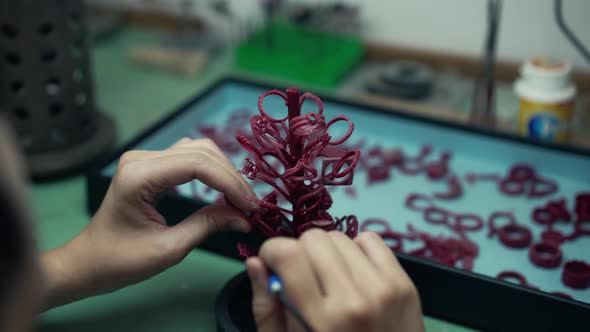 Red Accessory on Table in Workshop with Jeweller Working Indoors