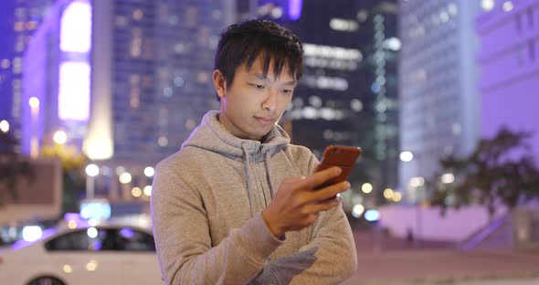 Man use of smart phone in the city at night