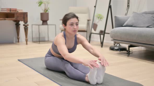 Young Indian Woman Doing Stretches on Yoga Mat at Home