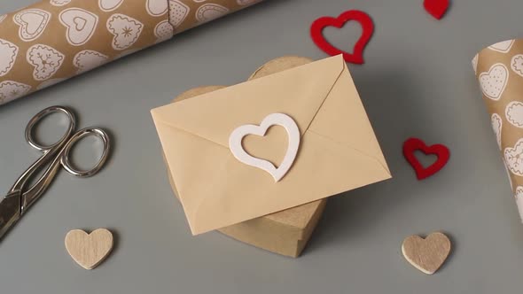 Small envelope with a heart over a valentine's day gift