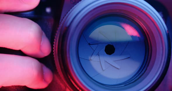 Adjusting Camera lens aperture with pink and purple light