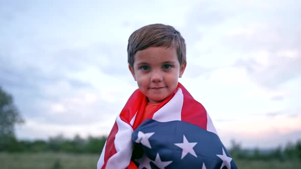 Portrait of Handsome Boy  American Patriot Child Stands with National Flag