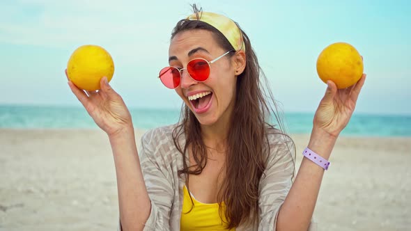 Funny Playful Young Woman Wearing Summer Clothes Holding Fruits Over Her Eyes