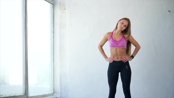 Warm-up of the Neck. Attractive Sporty Woman in Sportswear Doing Stretching