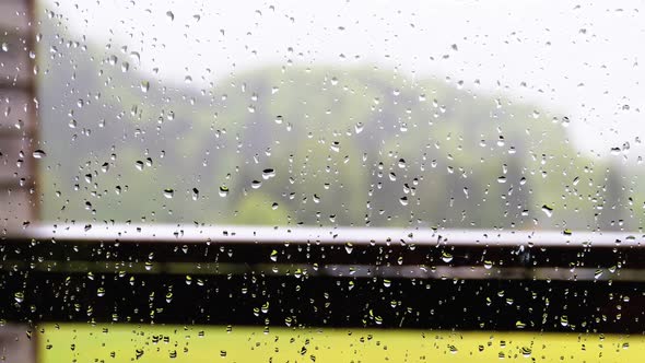 Raindrops on the Glass of a Plastic Window in House