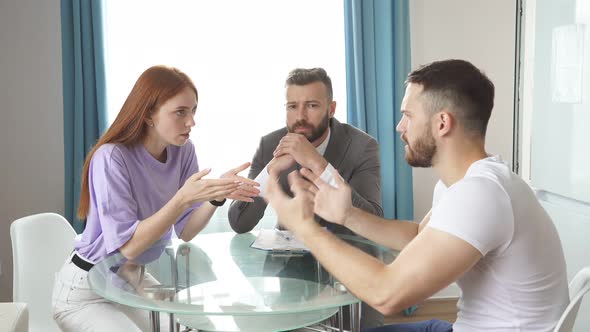 Young Caucasian Male Psychologist Listen To Couple Quarreling.