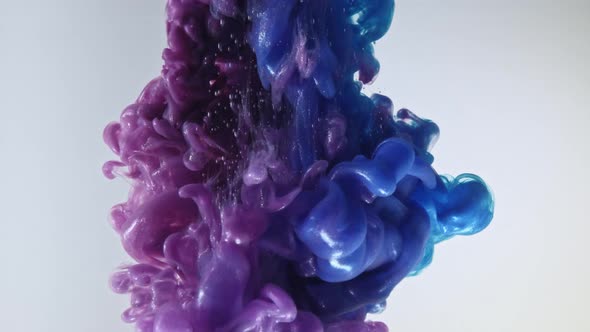 Colorful Nacreous Paint in Water Against White Background. alt