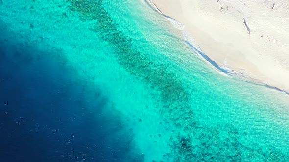 Blue azure lagoon washing pristine white sand of exotic beach, beautiful colorful sea texture seen f