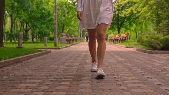 Close Up Legs in White Casual Sneakers