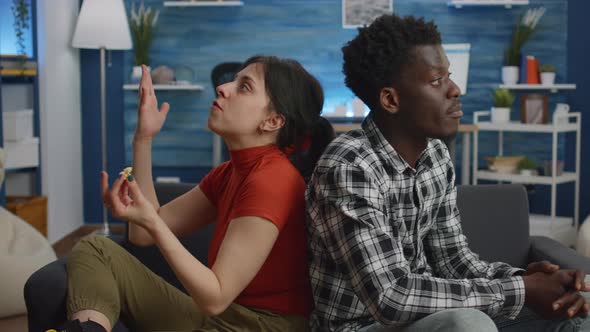 Interracial Couple with Marriage Problems Yelling in Living Room