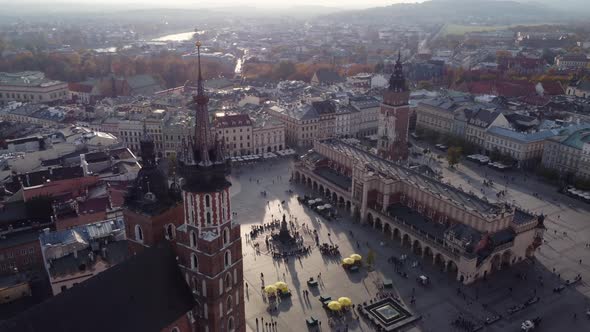 Aerial circling Main Market Square at golden hour, Krakow