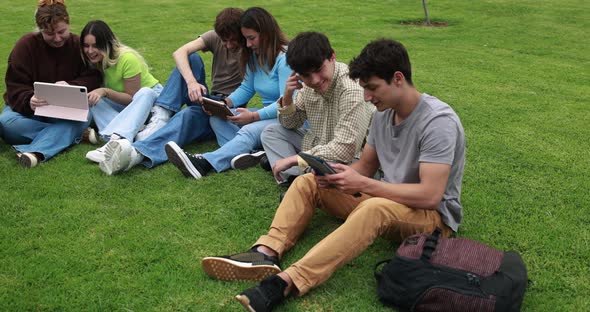 Young friends studying together outdoor sitting in university park