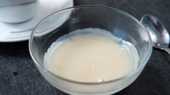 Falling Condensed Milk in a Bowl Close Up