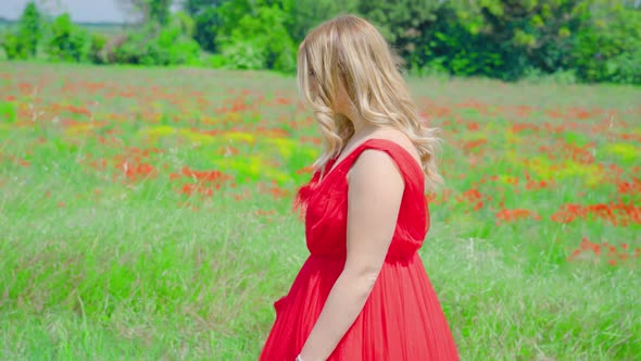 Young Girl with Red Dress Walks Among the Nature