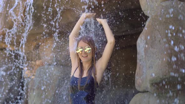 A Young Woman in a Tropical Resort with Hot Springs, Waterfalls and Swimming Pools with Hot Mineral