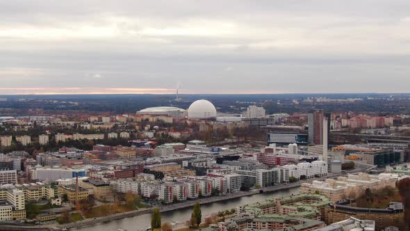 Wide aerial pull back from Stockholm Ericsson Globe showing skyline