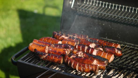 Grilling Tasty Sausages on Barbecue Grill