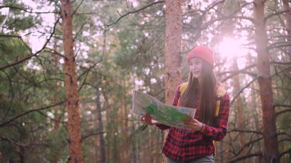 Happy Tourist Attractive Young Woman Is Travelling in Forest Then Looking at Map and Looking Around