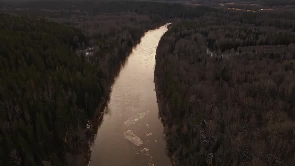 High View Huge Melting Ice Plate Flowing Along River Gauja Near Beautiful Sand Cliff Cinematic