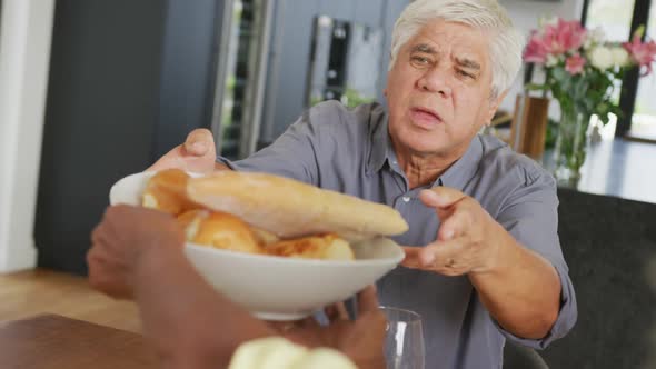 Happy senior diverse people having dinner at retirement home