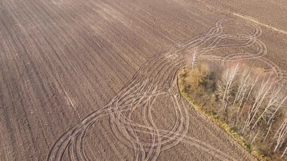 Beautiful Circular Traces of Agricultural Machinery in the Field Aerial View