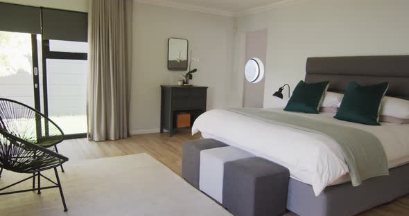 General view of luxury bedroom with large bed and night tables
