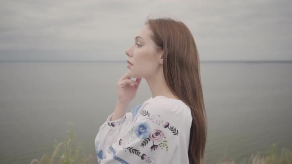 Adorable Carefree Young Woman Wearing Long Summer Fashion Dress Looking Confident at Camera Enjoying