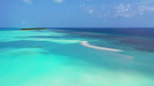 Daytime above abstract view of a sandy white paradise beach and aqua blue ocean background in high r