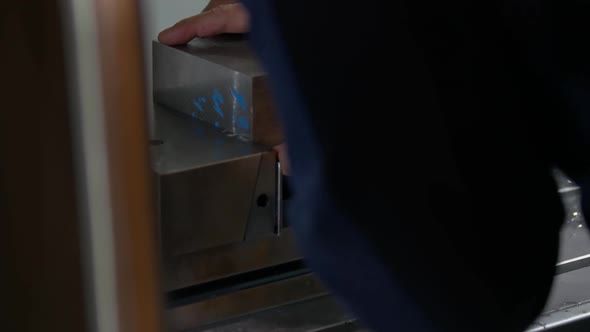 Worker is Installing Metal Block in a Locksmith Vice