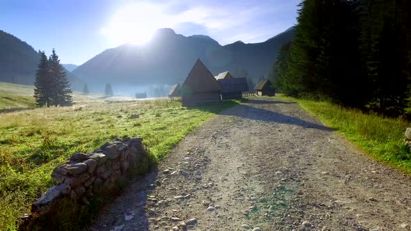 Footpath between cottages in the valley Chocholowska at sunrise, Tatra Mountains, Poland