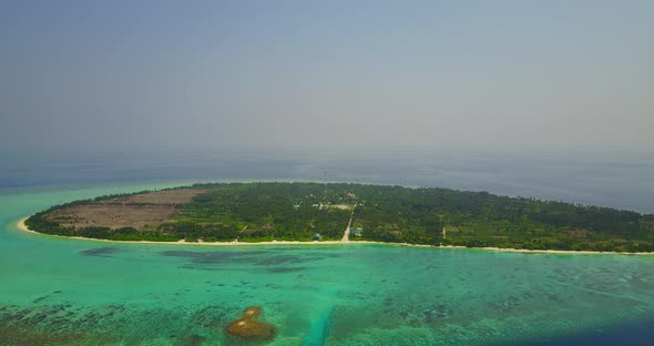 Natural drone travel shot of a summer white paradise sand beach and blue sea background in colorful 